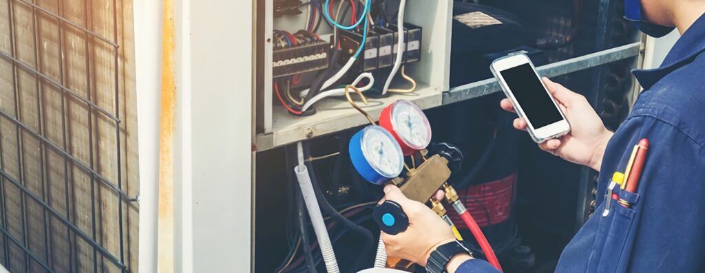 hvac technician working on AC