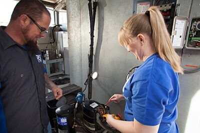 hvac technician repairing fan