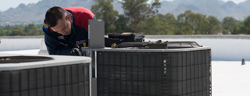 hvac technician repairing school ac