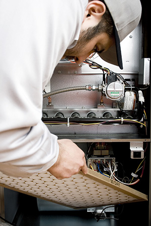 hvac technician changing air filter