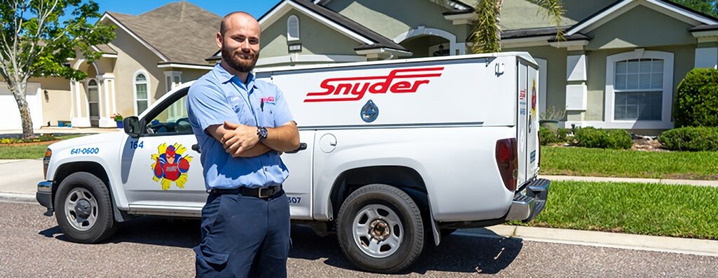 hvac technician in front of work truck