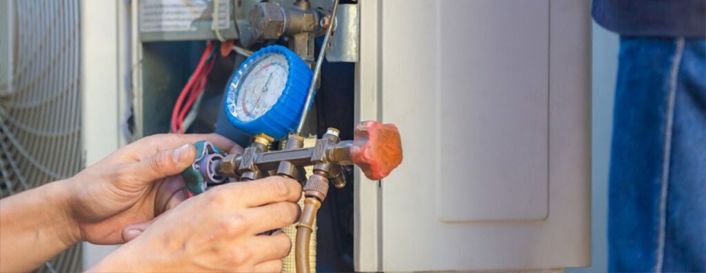 hvac technician using a manifold gauge