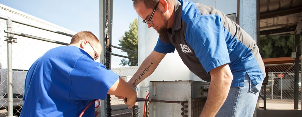 hvac technicians repairing unit