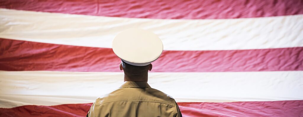 military veteran looking at us flag